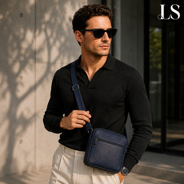 Man wearing a navy crossbody bag over a dark knit