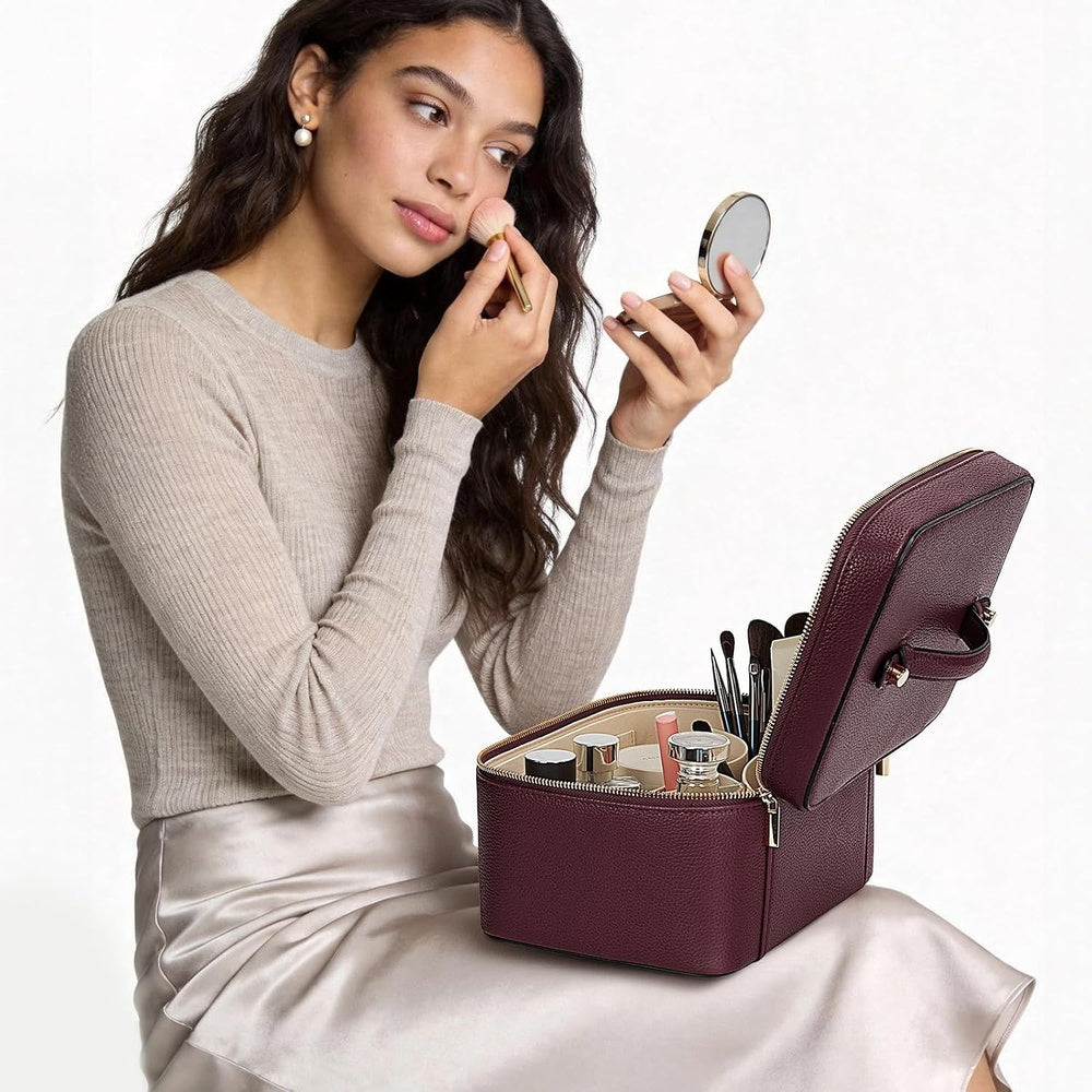 Woman applying make-up with the open case beside her